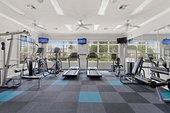 A large fitness room with treadmills and other exercise equipment